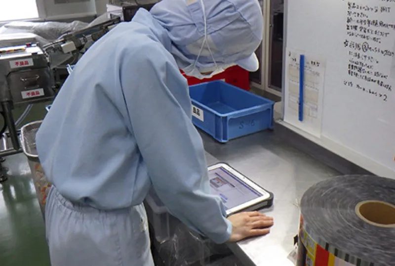 食品工場で業務用端末を使用している様子